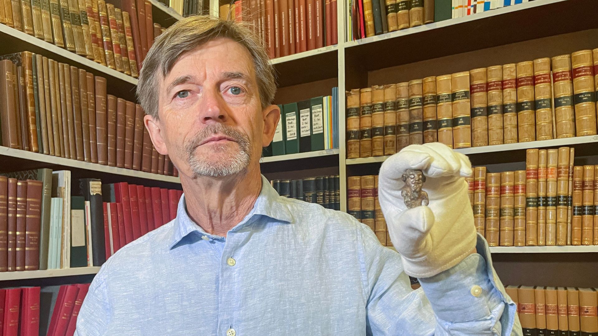 Denmark's national museum curator Peter Pentz with the figurine. /Camille Bas-Wohlert/AFP
