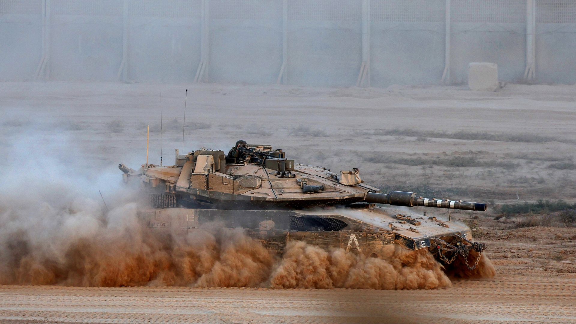 An Israeli army tank rolls along the separation fence on the border with the Gaza Strip in southern Israel, on September 3. /Jack Guez/AFP