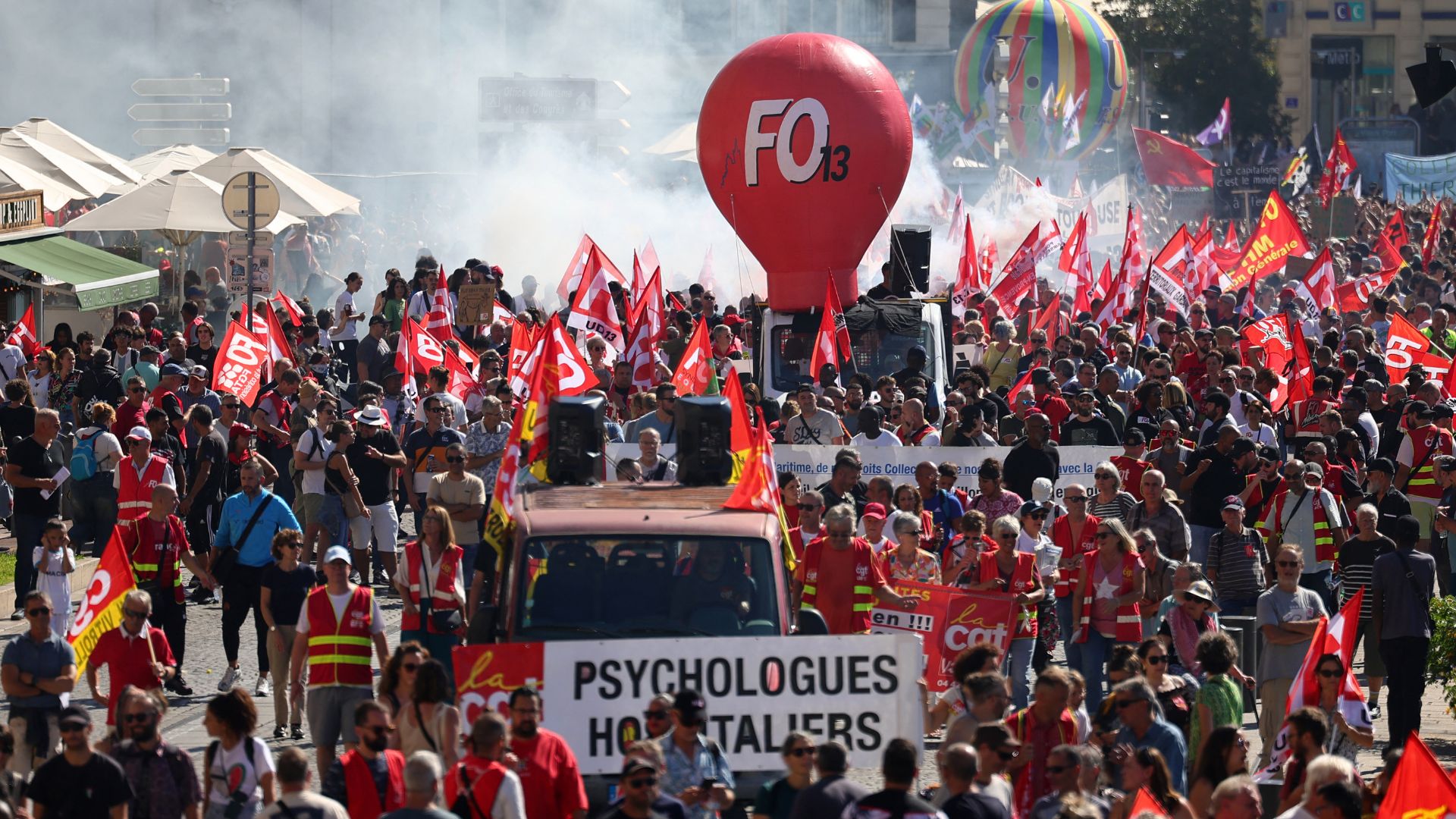 Protesters march with unions' flags at the port in Marseille. /Clement Mahoudeau/AFP
