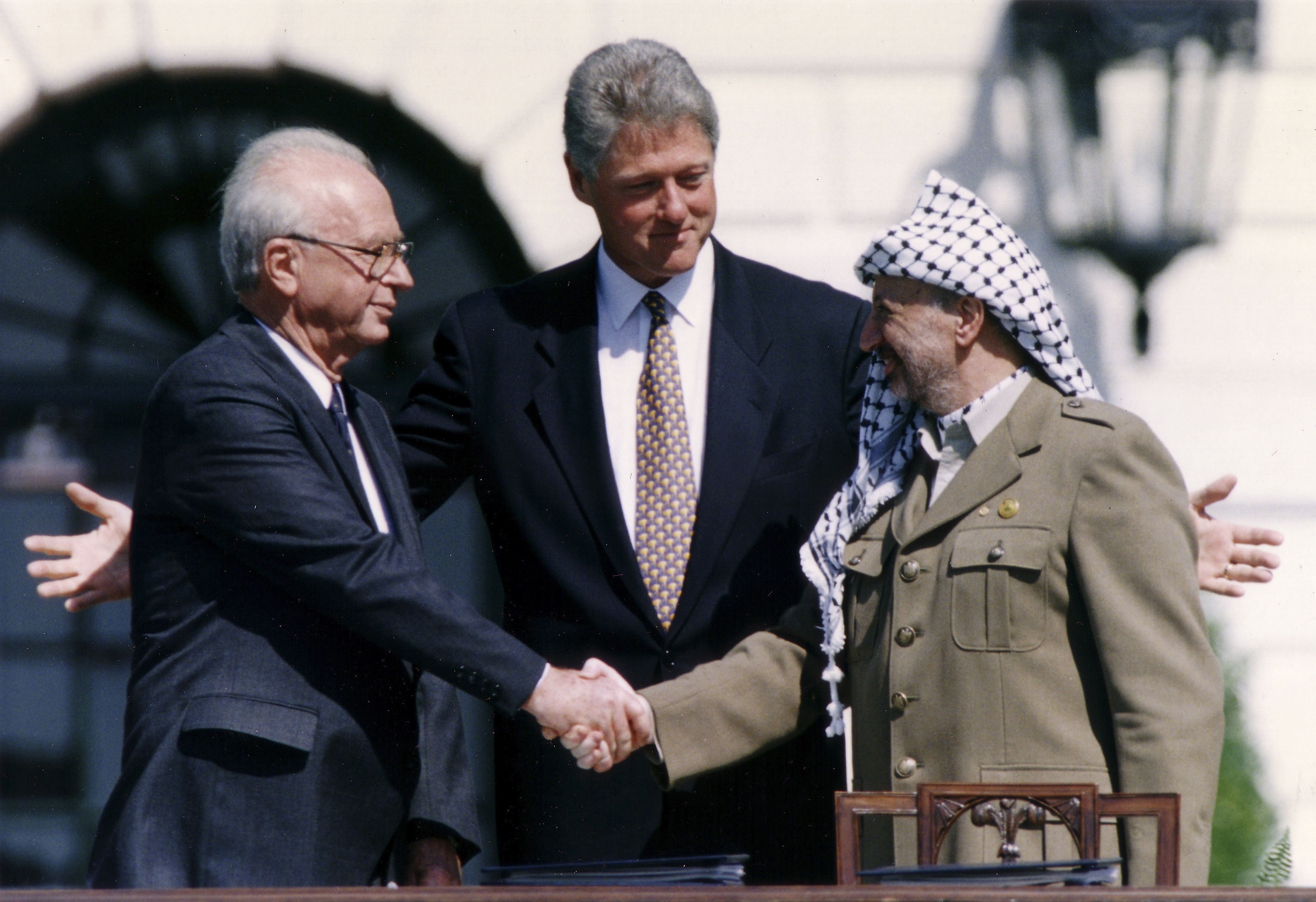 Israeli Prime Minister Yitzhak Rabin (left) shakes hands with PLO Chairman Yasser Arafat (right) at the signing of the Oslo Accords in 1993. /Gary Hershorn/Reuters

