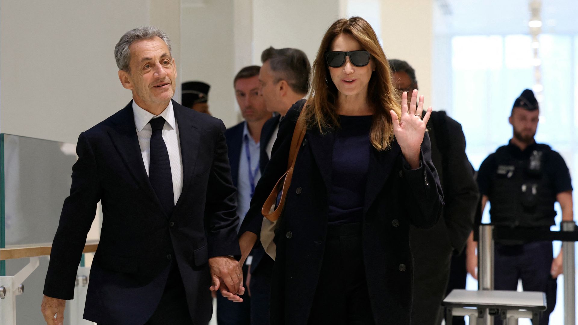 Former French president Nicolas Sarkozy with his wife Carla Bruni arrives for the verdict in his trial for illegal campaign financing from Libya for his successful 2007 presidential bid. /Alain Jocard/AFP
