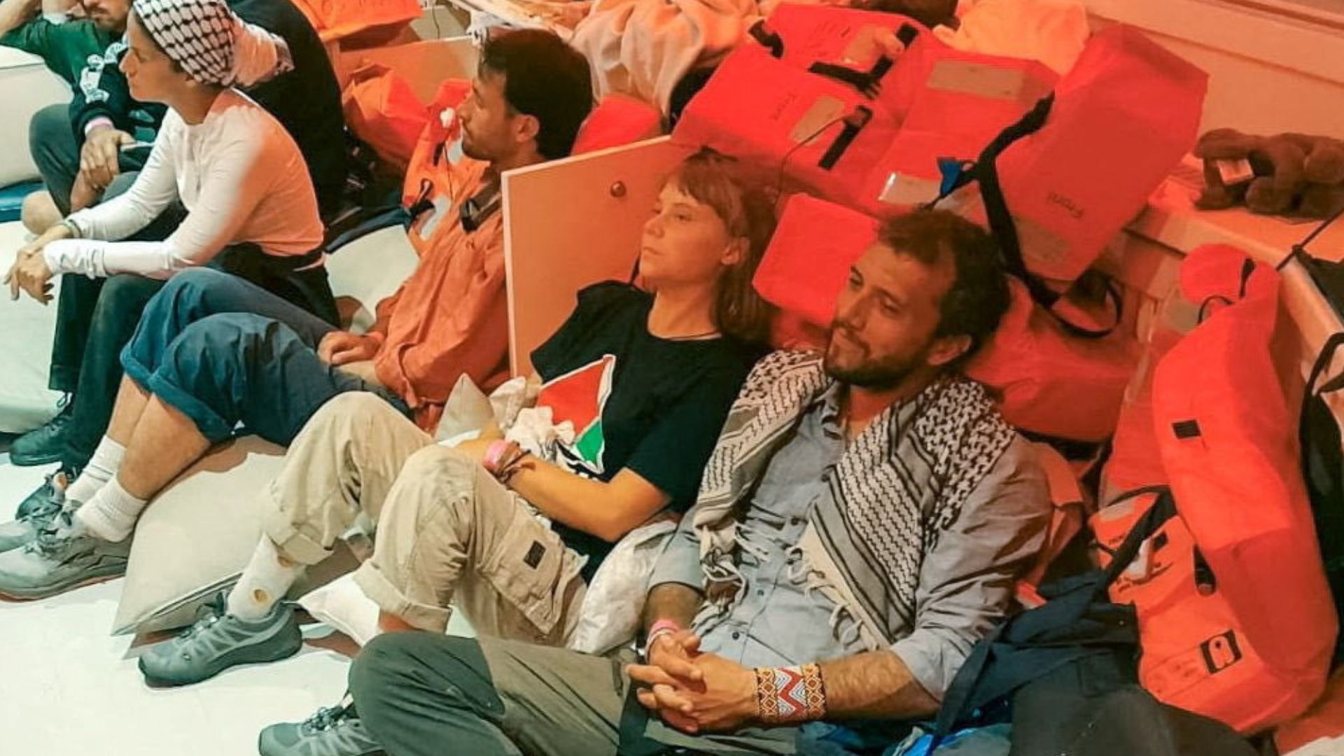 Swedish activist Greta Thunberg and Brazilian activist Thiago Avila sit in a vessel making their way to Israel, after Israel intercepted some of the vessels of the Global Sumud Flotilla. /Israeli Foreign Ministry via Reuters 