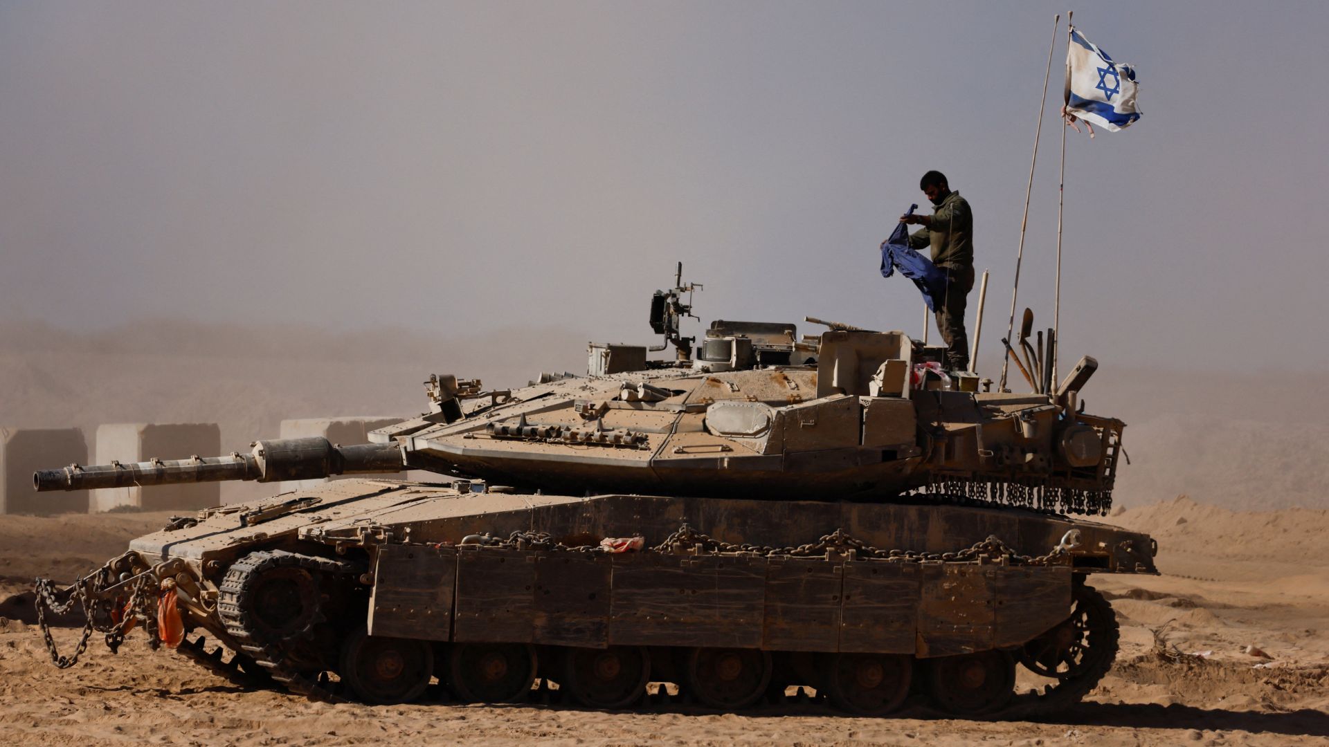 An Israeli soldier stands on a tank on the Israeli side of the border with Gaza on August 20. /Amir Cohen/Reuters
