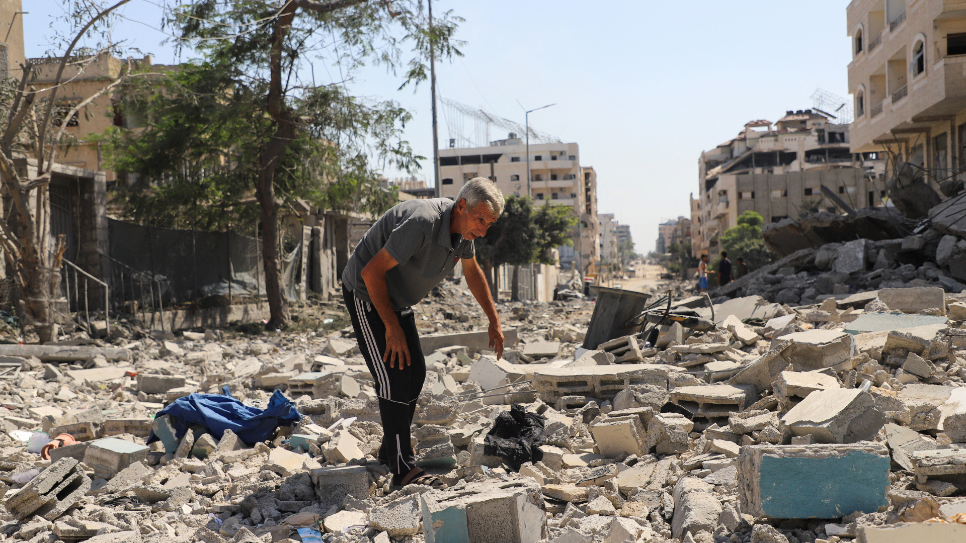 A Palestinian man inspects the damage at a residential neighborhood, following an Israeli operation in the area. /Ebrahim Hajjaj/Reuters