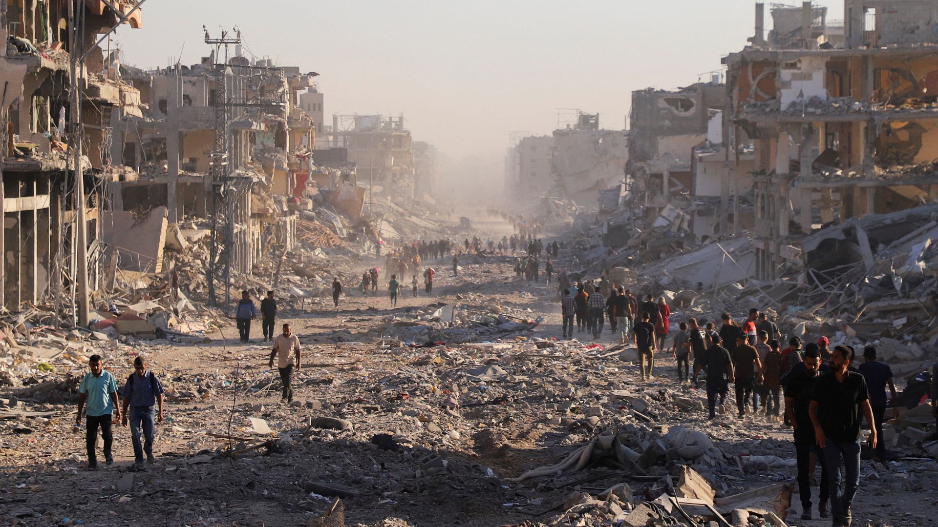 Palestinians in a damaged neighborhood in Gaza City on Friday. /Ebrahim Hajjaj/Reuters