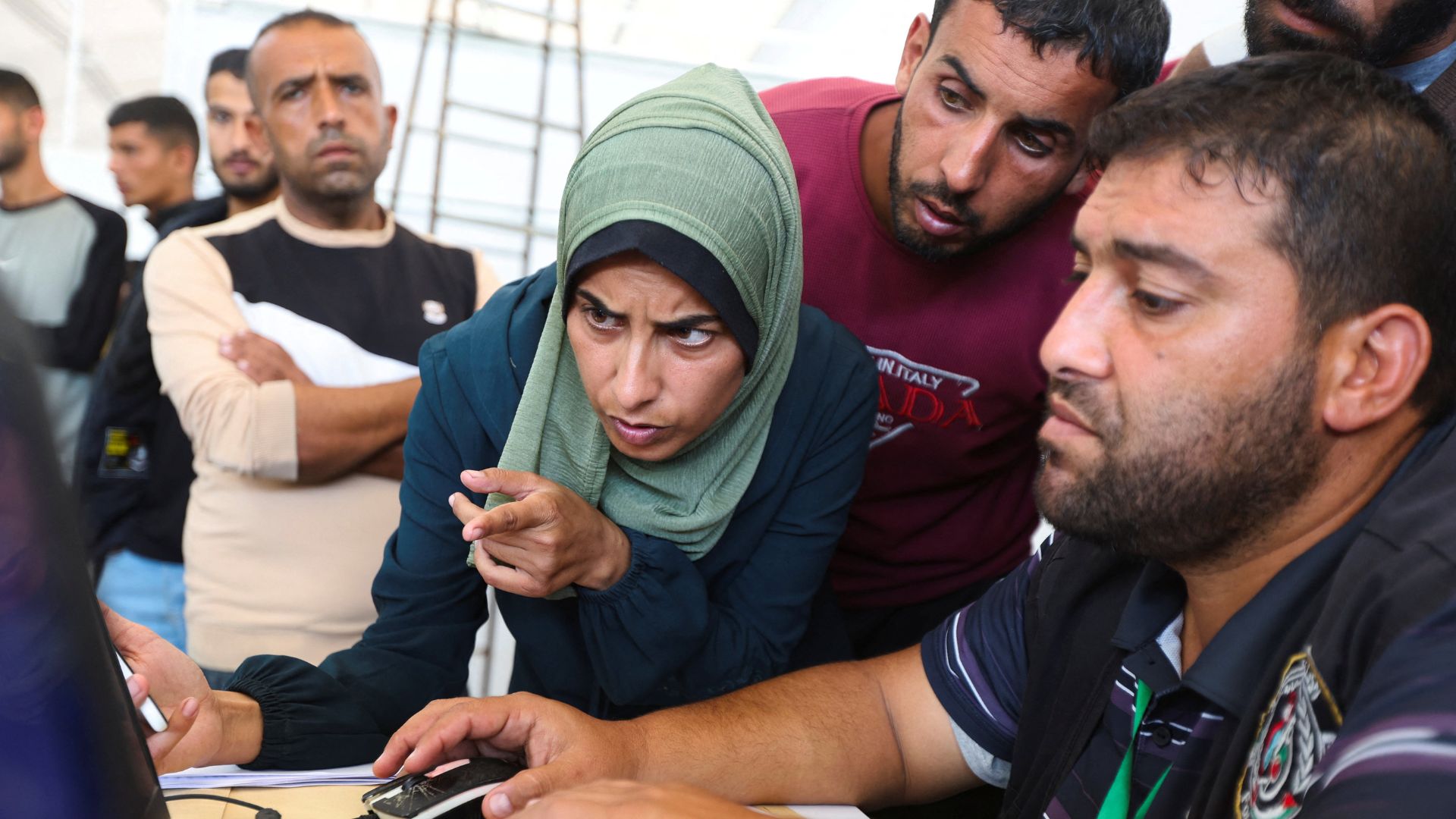 A Palestinian woman attempts to identify her missing husband among the bodies handed over to the Red Cross. /Ramadan Abed/Reuters