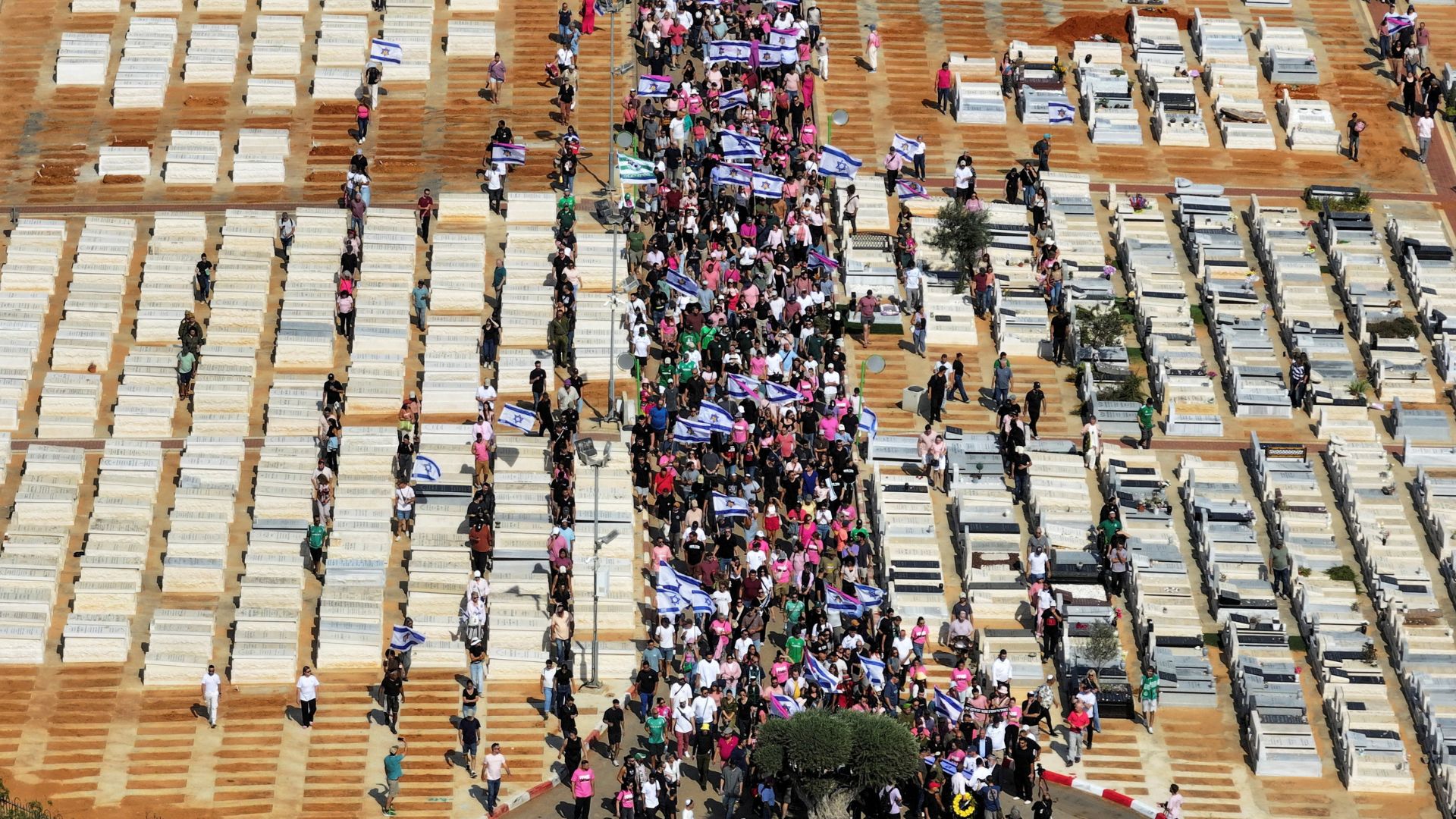 A drone view shows mourners dressed in pink honouring a Israeli victim of the October 7 Hamas attack whose body was returned home. /Ilan Rosenberg/Reuters