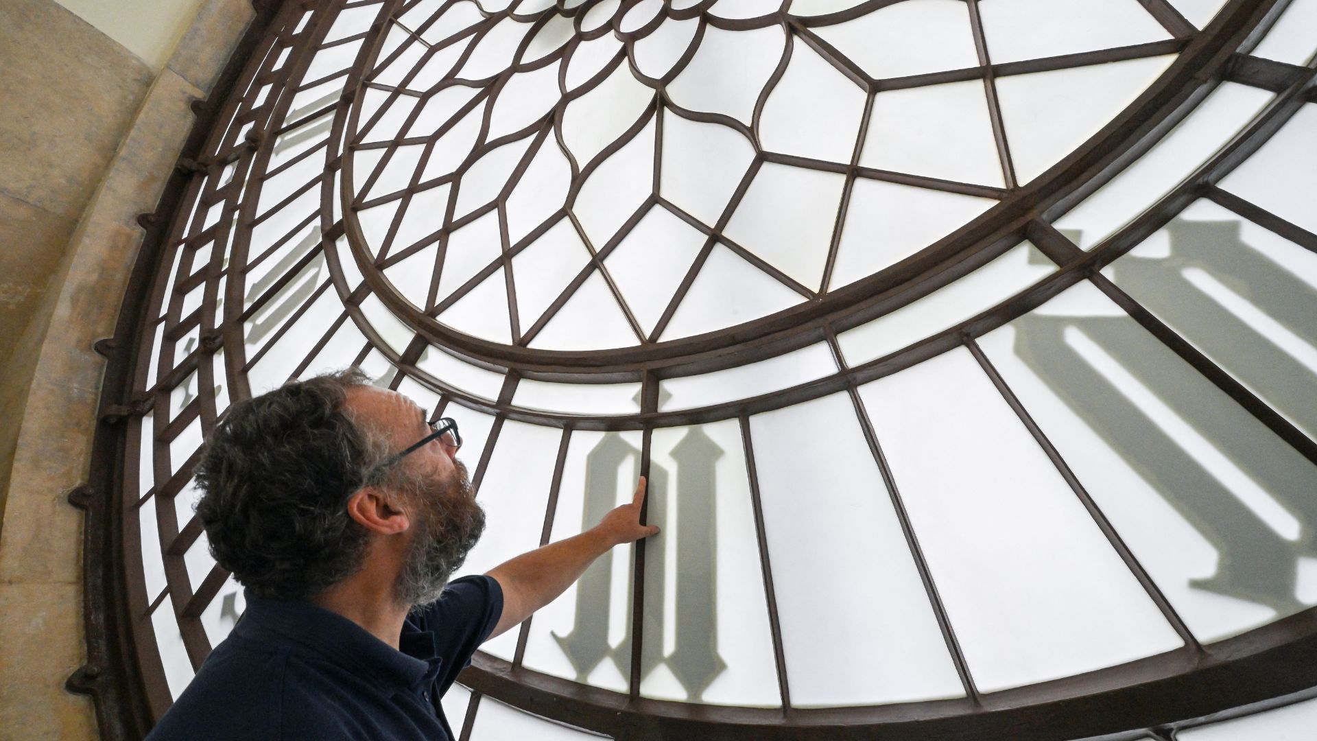 Clock mechanic Huw Smith inspects the internal side of the clock face at Big Ben, in London's Houses of Parliament. /Justin Tallis/AFP
