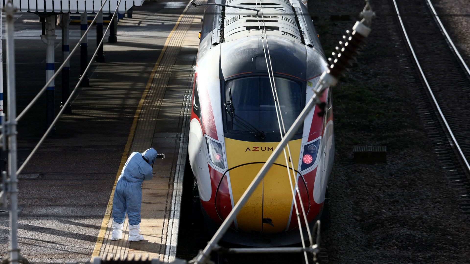 A forensic officer takes pictures of the London North Eastern Railway train where a series of stabbings took place, at a platform at Huntingdon Station, near Cambridge. /Jack Taylor/Reuters/
