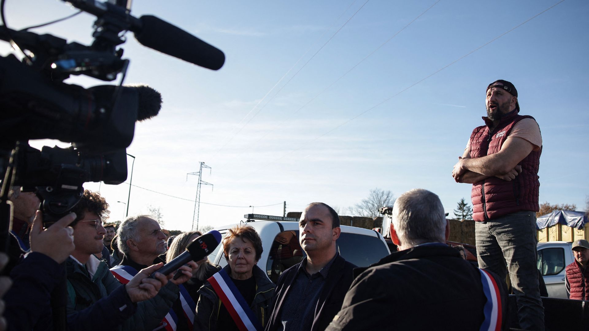 French agricultural activist Jerome Bayle speaks with farmers and journalists before blocking the A64 motorway, during a demonstration in Carbonne, south-western France, on Friday. /Valentine Chapuis/AFP