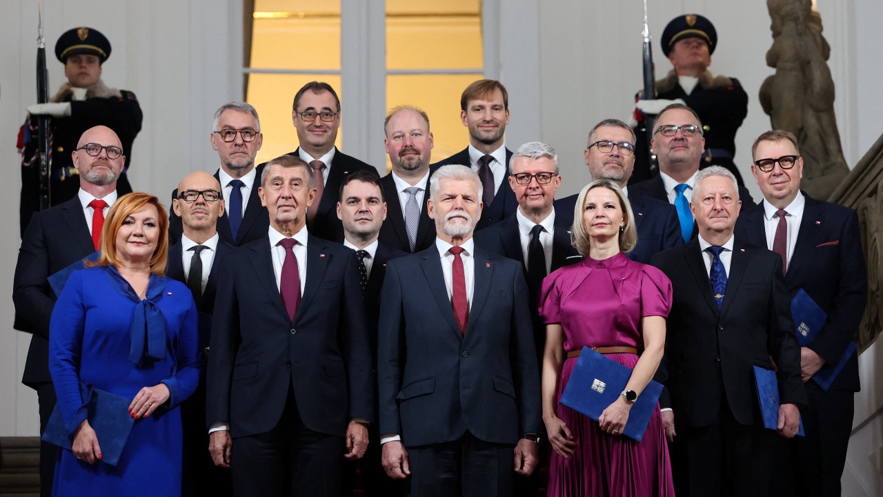 Czech President Petr Pavel and Prime Minister Andrej Babis pose for a photo with newly appointed members of the Czech government after the cabinet's inauguration at Prague Castle. /Eva Korinkova/Reuters
