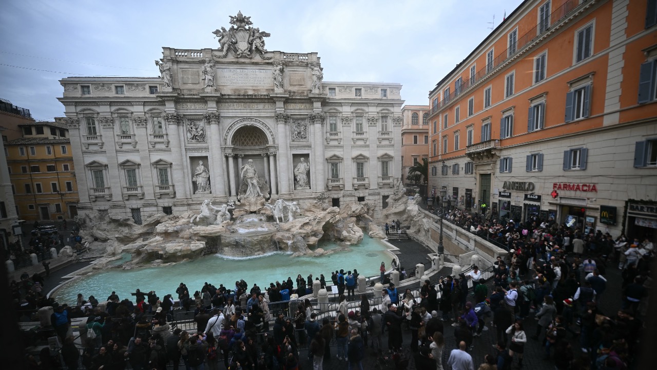 Tourists will have to pay a €2 entrance fee to get close to Rome's famous Trevi Fountain, which draws vast crowds daily. /Filippo Monteforte/AFP