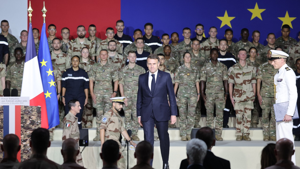France's President Emmanuel Macron (C) arrives with Chief of Staff of the French Armed Forces Fabien Mandon (center L) to address French troops during a ceremony at the 5th Cuirassier Regiment's base in Zayed Military City, near Abu Dhabi. /Ludovic Marin/AFP