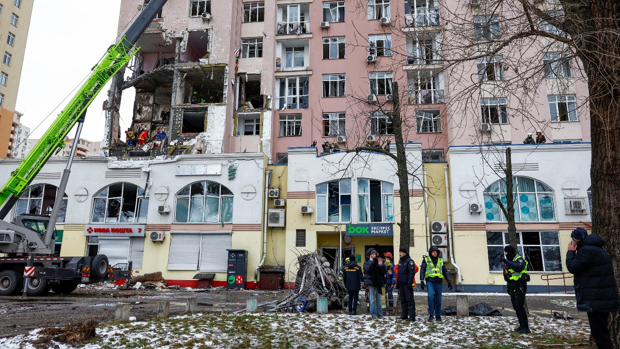 Rescuers and police officers stand at the site of an apartment building hit during Russian missile and drone strikes in Kyiv, Ukraine. /Valentyn Ogirenko/Reuters