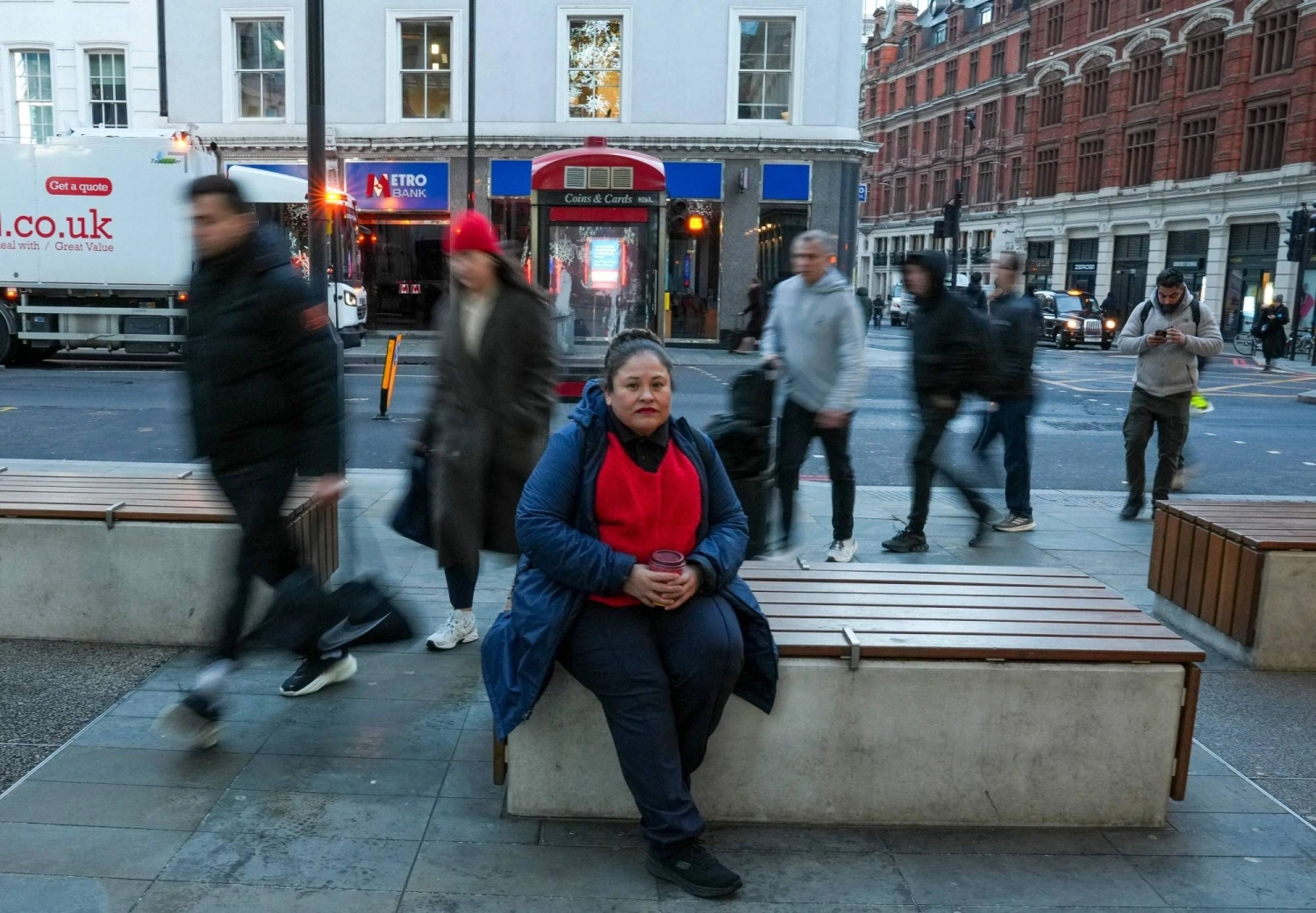 Roxana Panozo Alba, from Bolivia, is a cleaner in an office building. /Henry Nicholls/AFP