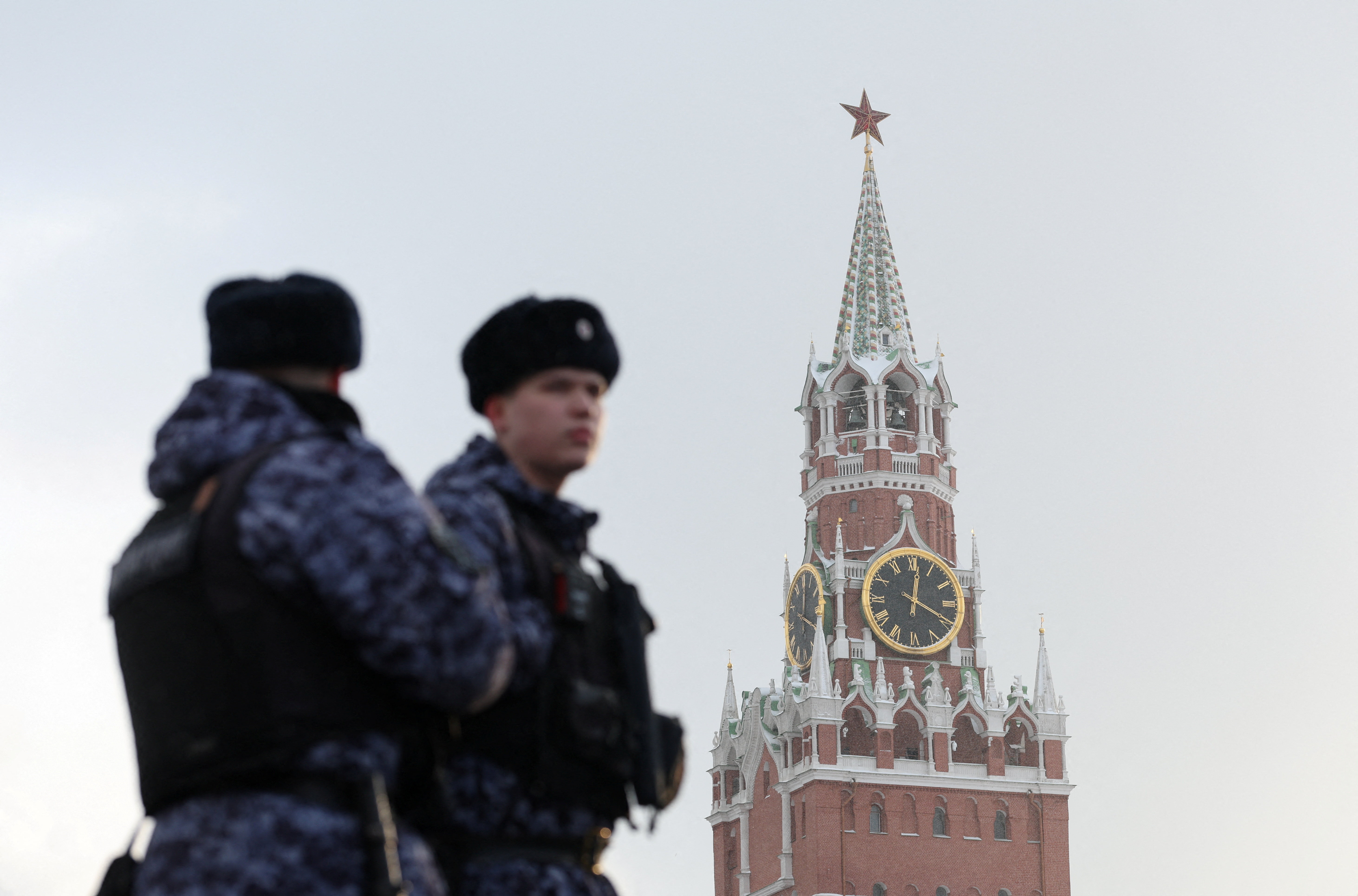 Russian law enforcement officers stand guard near the Spasskaya Tower of the Kremlin in central Moscow. /Ramil Sitdikov/Reuters