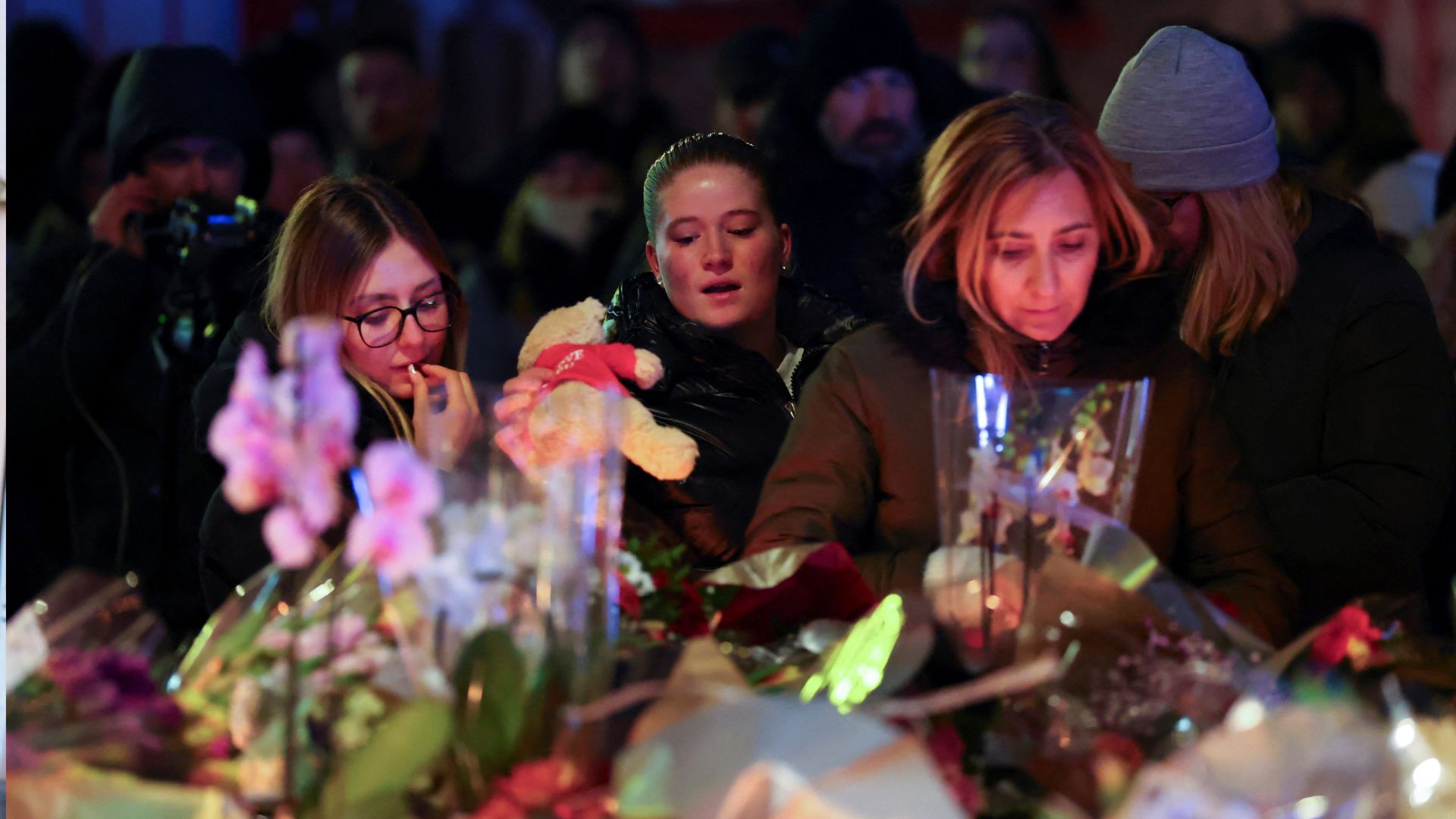 People leave flowers outside the 