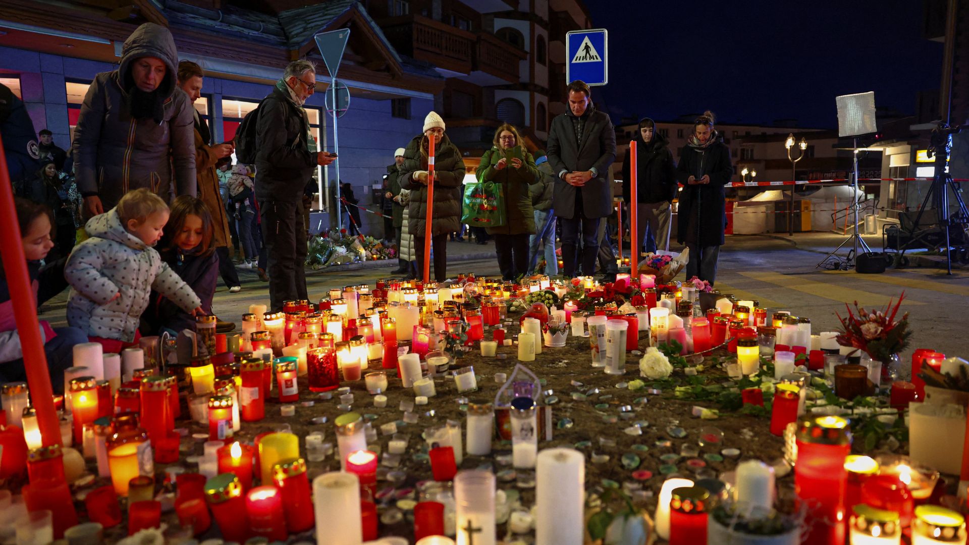 People gather by a makeshift memorial near the Constellation bar on Friday. /Denis Balibouse/Reuters