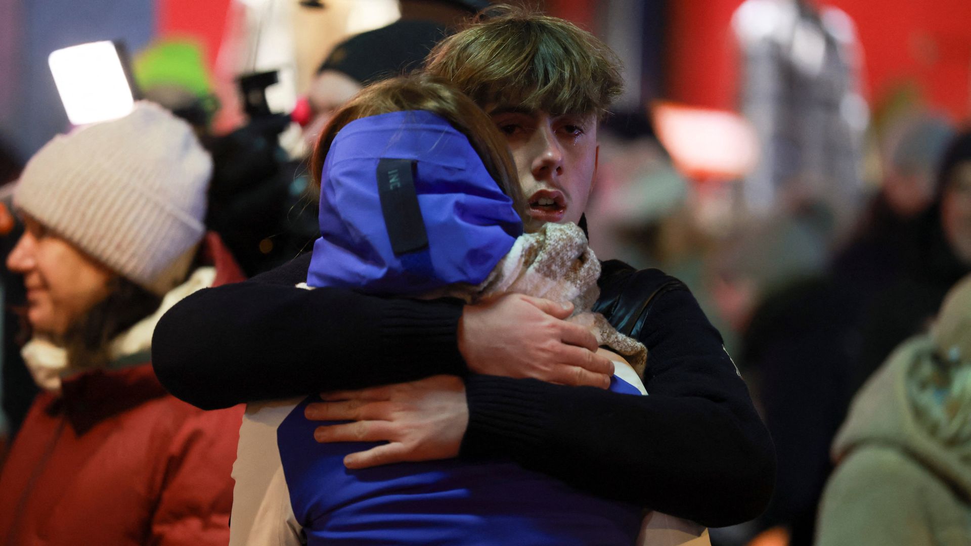 People embrace outside the Constellation bar on Friday. /Stephanie Lecocq/Reuters