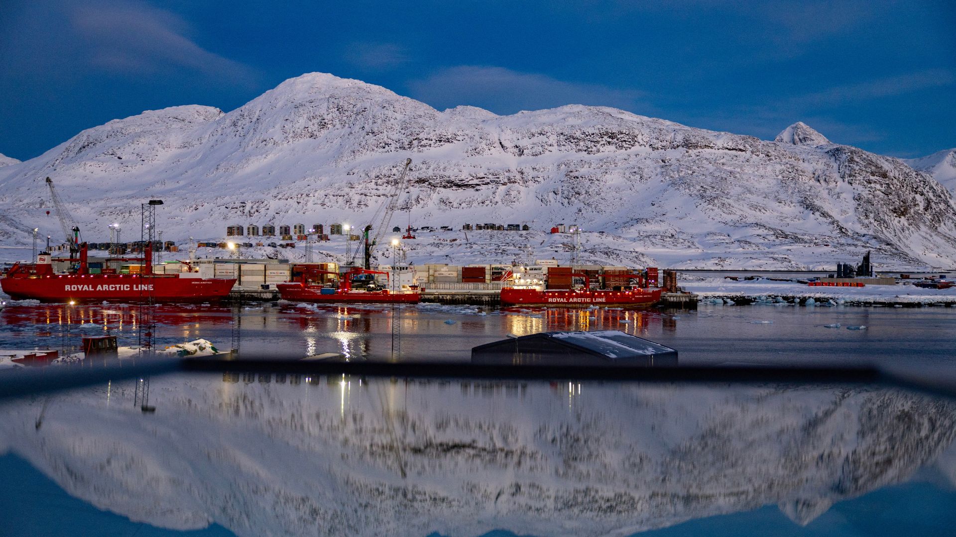 The port and the mountain behind are reflected in a window in Nuuk, Greenland, March 7, 2025. /Odd Anderson/AFP