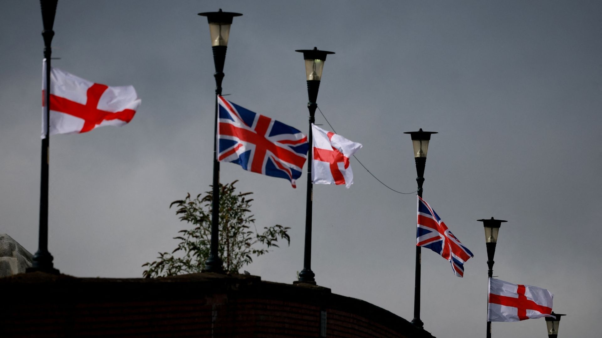 English and British flags tied to lampposts in Ellesmere Port, UK, last September. /Phil Noble/Reuters

