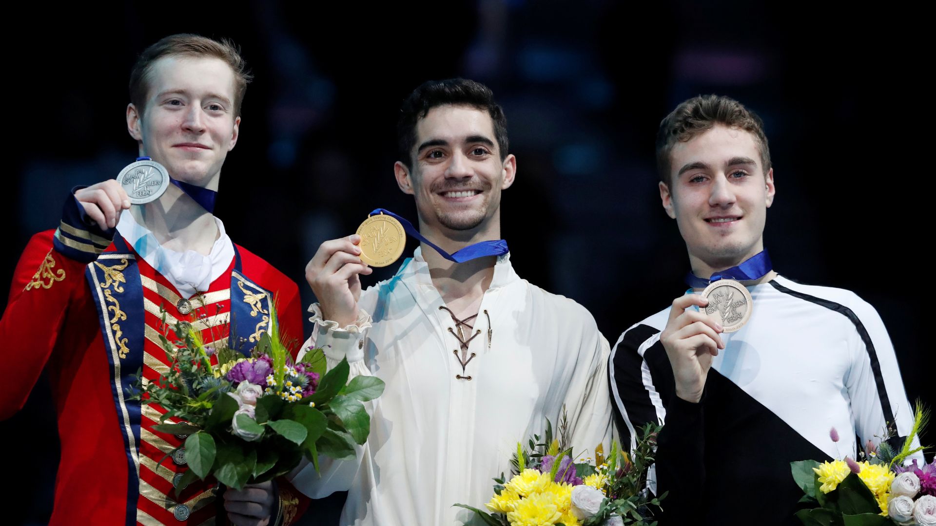 Spain's Javier Fernandez (center) celebrates winning the Men's Free Skating with second placed Russia's Alexander Samarin and third placed Italy's Matteo Rizzo on the podium at the 2019 ISU European Figure Skating Championships in Minsk. /Vasily Fedosenko/Reuters
