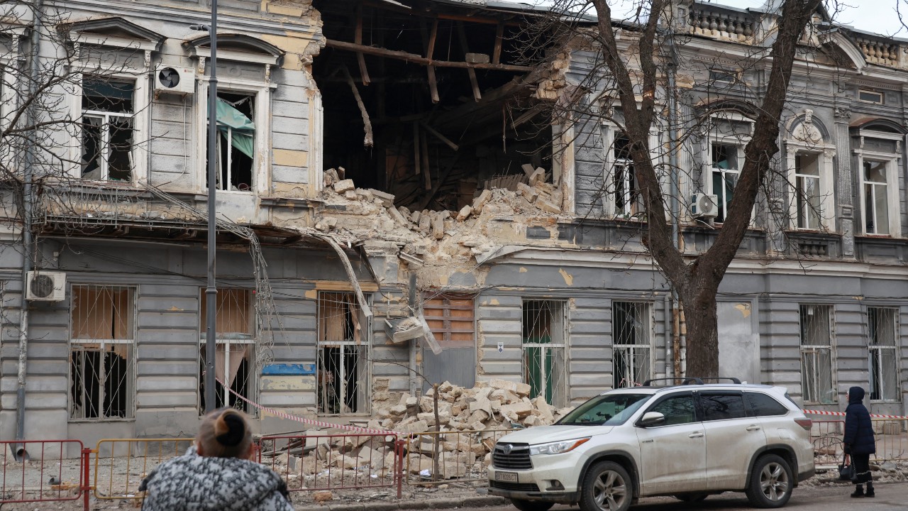 Residents look at a lyceum building hit by a Russian drone strike in Odessa, Ukraine. /Nina Liashonok/Reuters