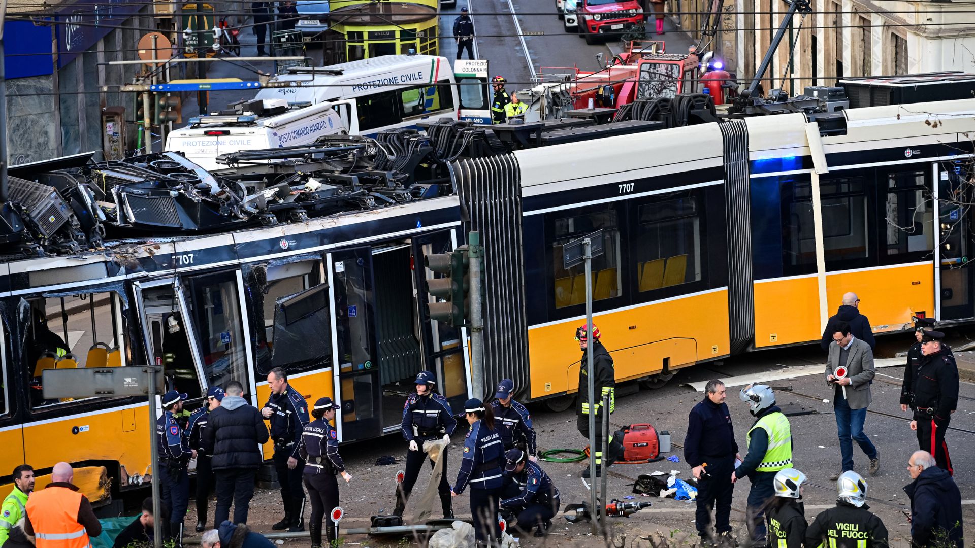 Italian police officers and firefighters operate at the site of a tram derailment in Milan on February 27. /Piero Cruciatti/AFP