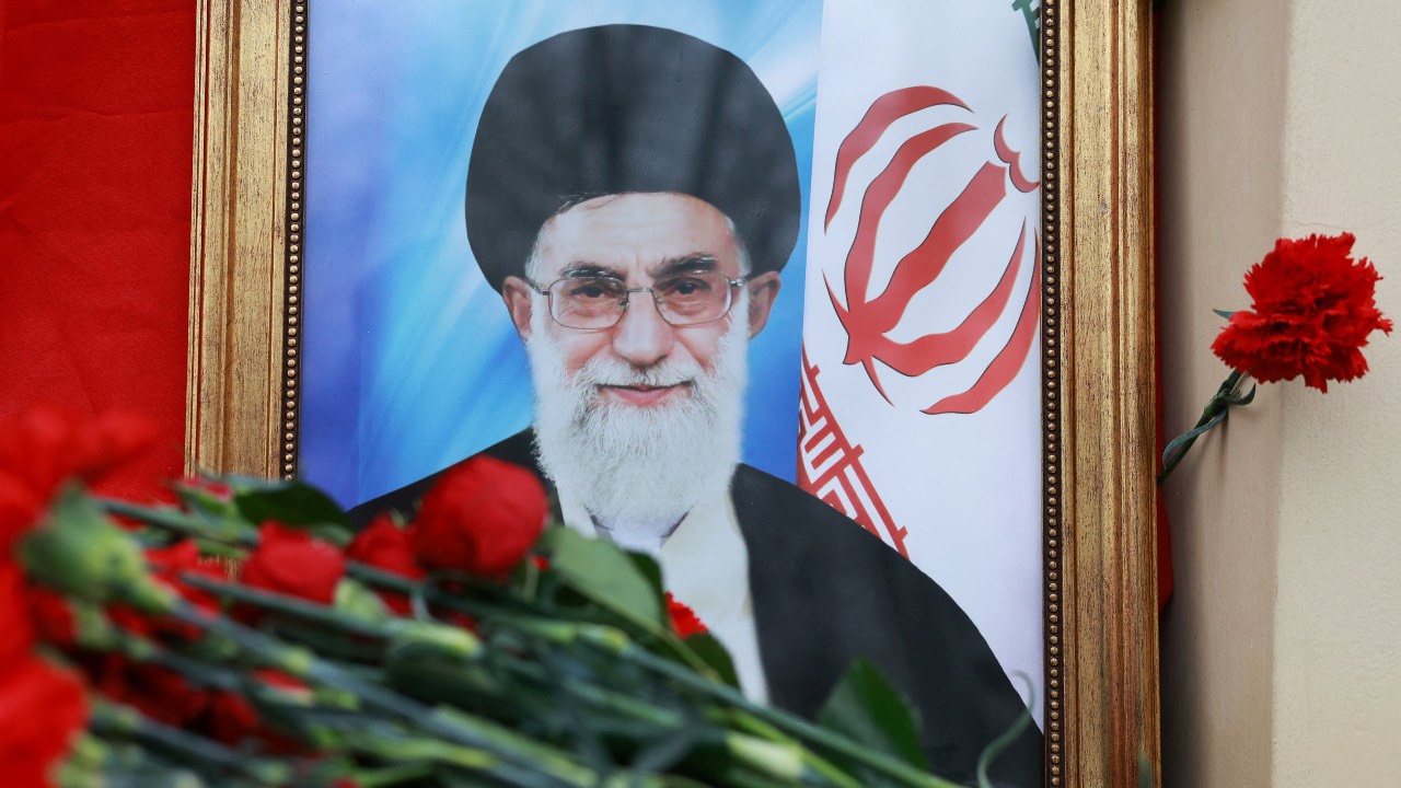 A portrait of Iran's late Supreme Leader Ayatollah Ali Khamenei, who was killed in Israeli/US strikes on Saturday, stands among flowers outside the Iranian Embassy in Moscow, Russia. /Ramil Sitdikov/Reuters