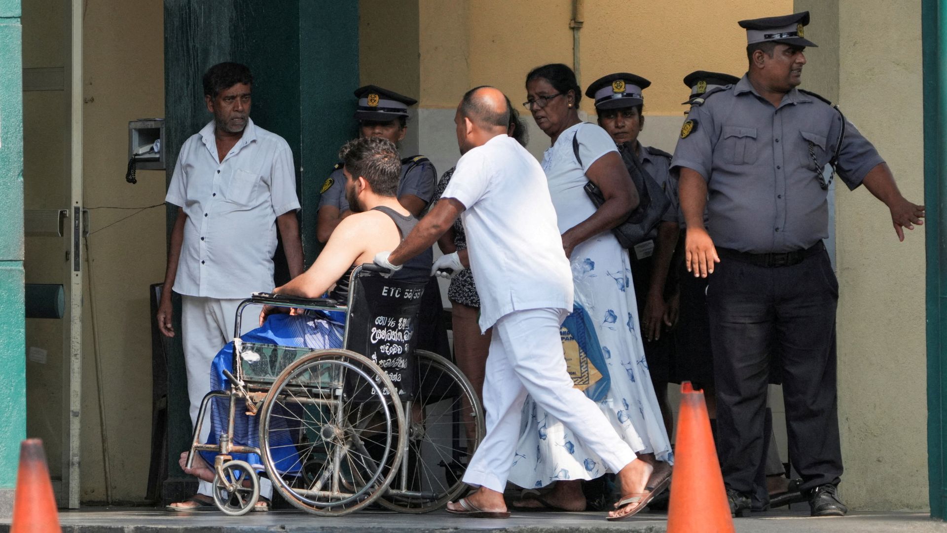 An injured person moves on a wheelchair at the National Hospital Galle where he will receive treatment after a submarine attack on the Iranian military ship, Iris Dena, off Sri Lanka, in Galle. /Thilina Kaluthotage/Reuters
