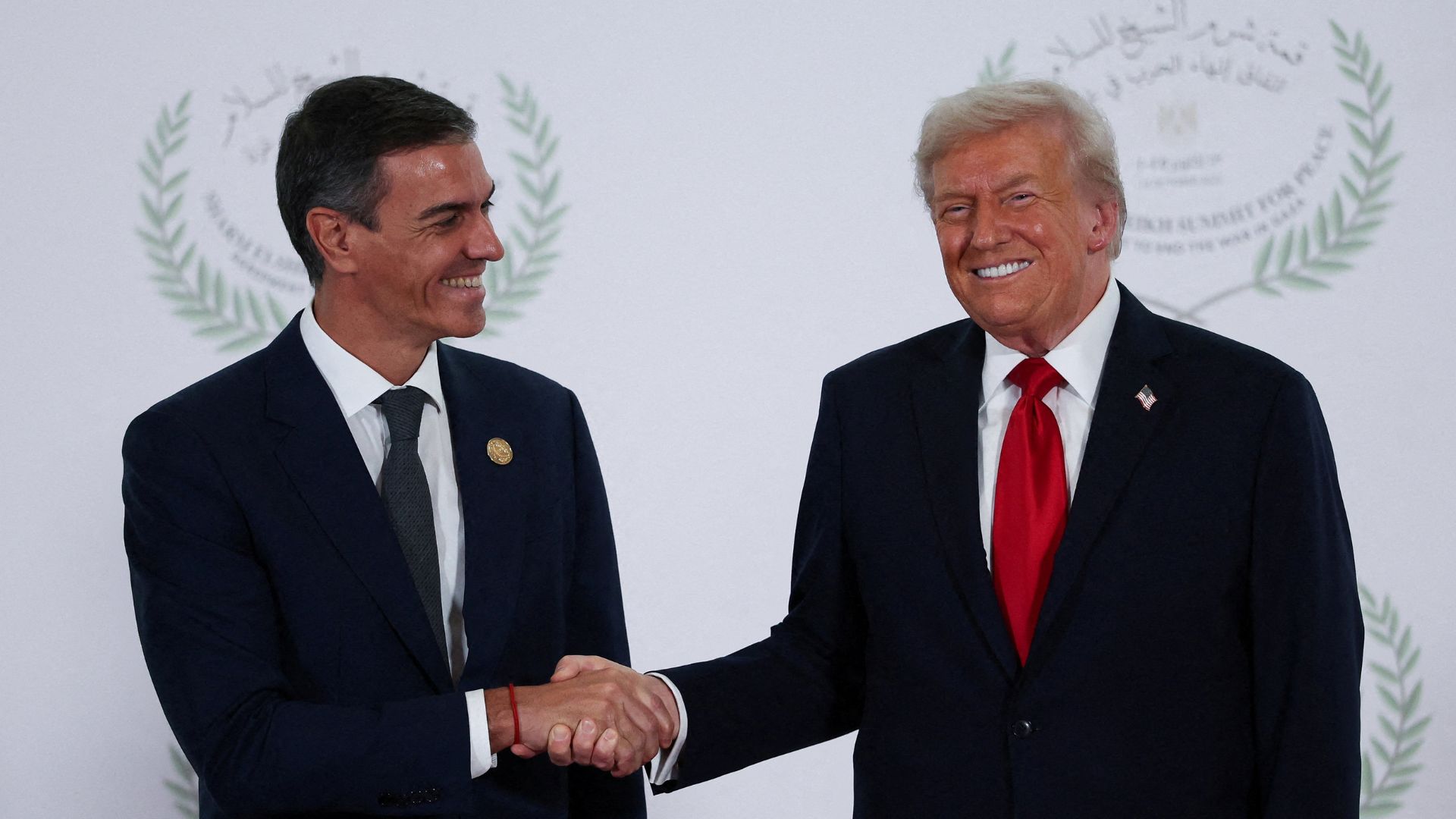 U.S. President Donald Trump and Spanish Prime Minister Pedro Sanchez shake hands as they pose for a photo, at a world leaders' summit on ending the Gaza conflict, in Sharm el-Sheikh, Egypt, October 13, 2025. /Suzanne Plunkett/Pool/File