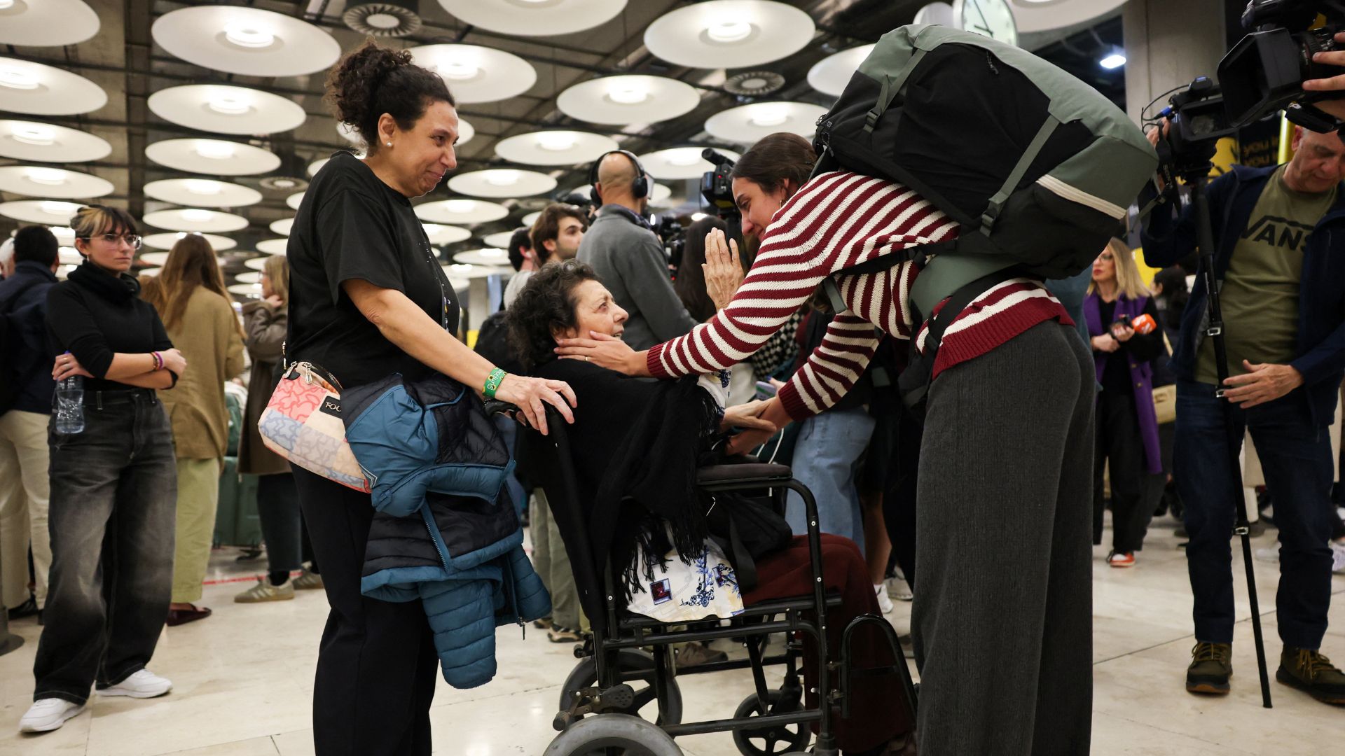 People greet one another as Spanish citizens evacuated from Abu Dhabi arrive at Adolfo Suarez Madrid-Barajas airport, amid the U.S.-Israel conflict with Iran, in Madrid on March 3. /Violeta Santos Moura/Reuters
