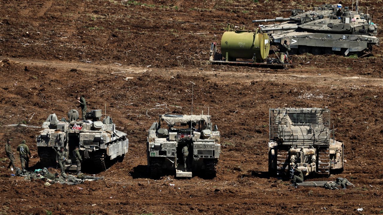 Israeli soldiers stand next to military vehicles on the Israeli side of the Israel-Lebanon border, amid escalation between Hezbollah and Israel, and amid the US-Israeli conflict with Iran, in northern Israel. /Amir Cohen/Reuters
