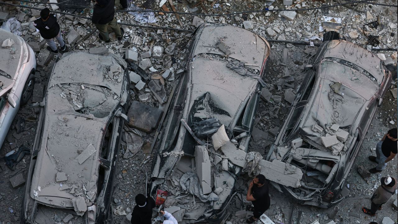 Residents gather at the site of an Israeli airstrike that targeted a building in the Aisha Bakkar neighbourhood of Beirut on March 11. /Ibrahim Amro/AFP
