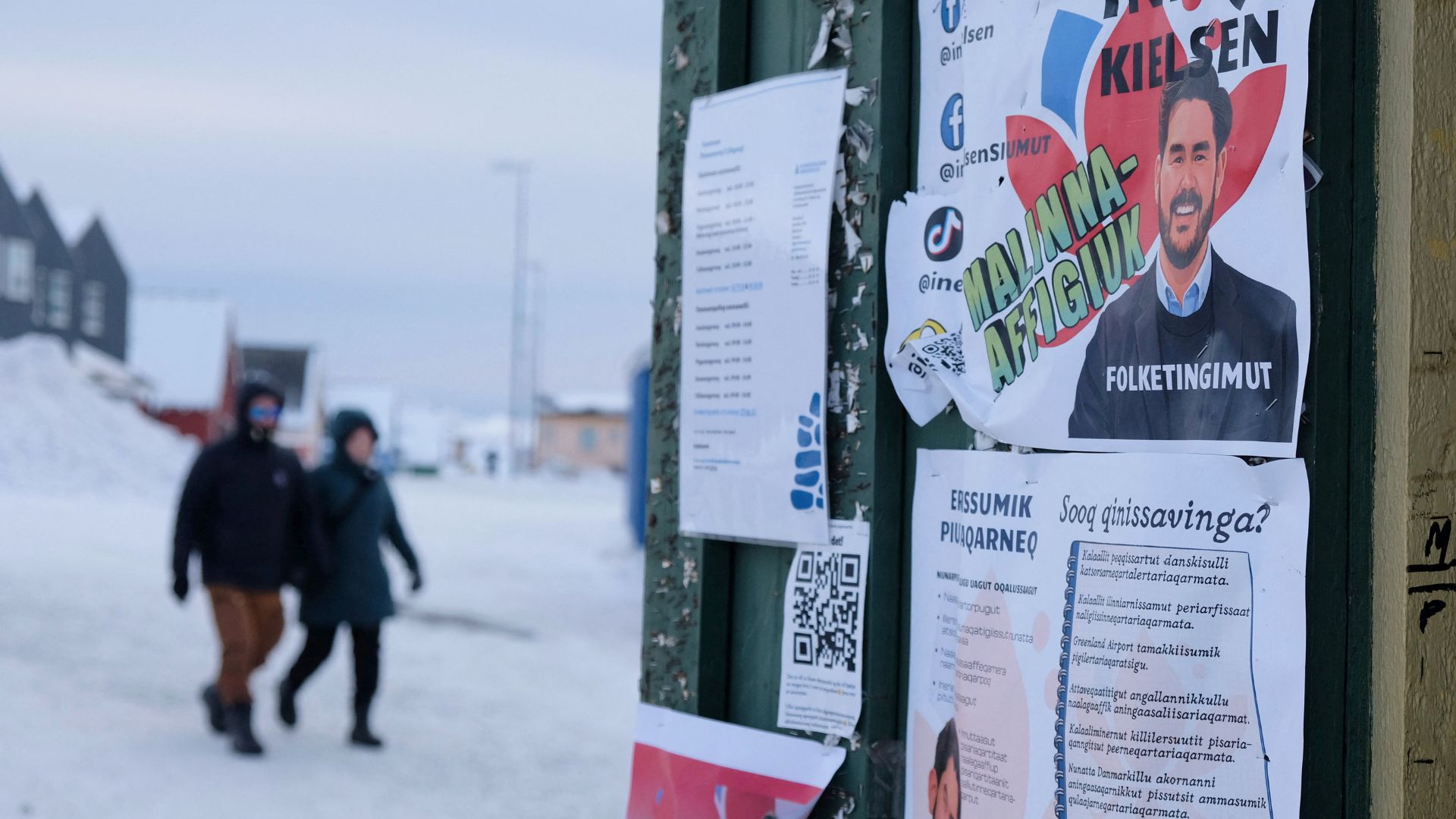 People walk past posters for candidates in the upcoming Danish elections in Nuuk. /Tim Barsoe/Reuters

