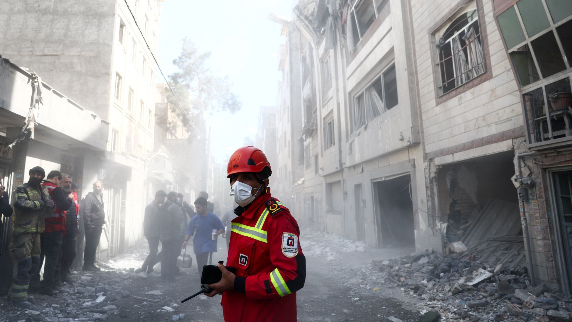 Emergency responders inspect the site of a residential building damaged by a strike, amid the US-Israeli conflict with Iran, in Tehran. /Majid Asgaripour/WANA (West Asia News Agency) 
