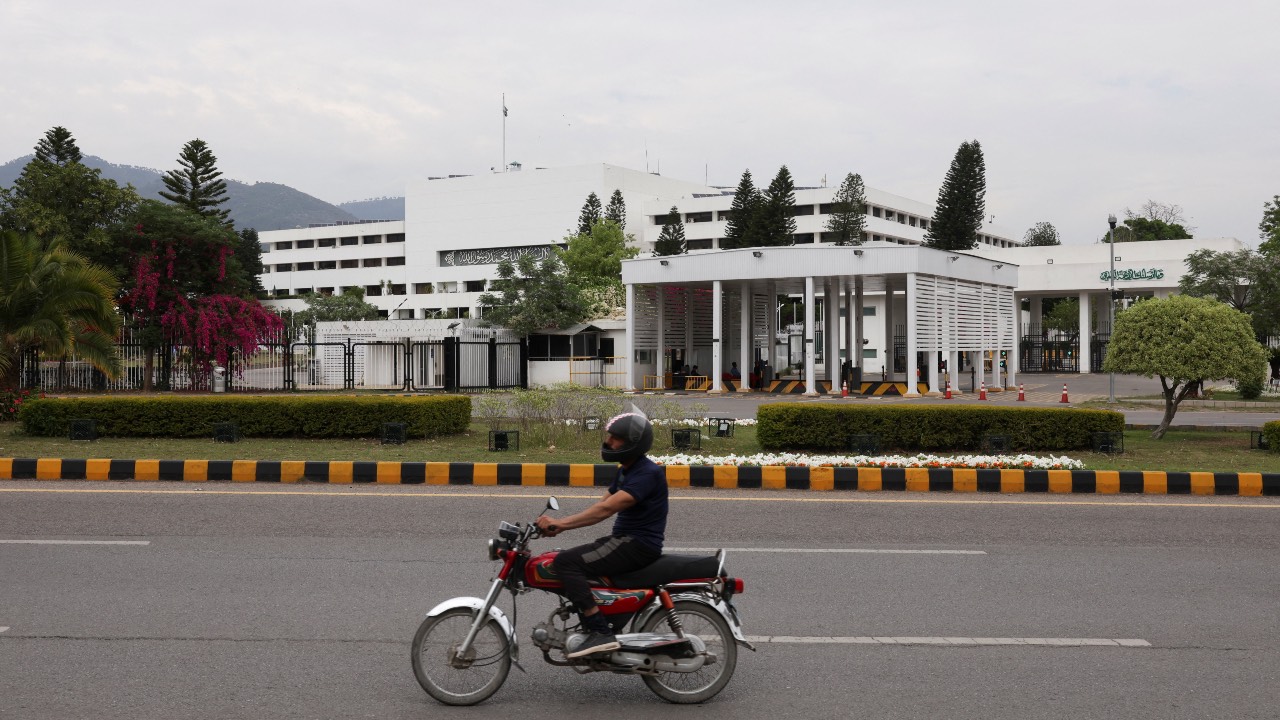 A man on a motorbike rides past the Parliament House building, as Pakistan hosts talks with Saudi Arabia, Türkiye and Egypt to discuss regional de-escalation in Islamabad, Pakistan. /Akhtar Soomro/Reuters