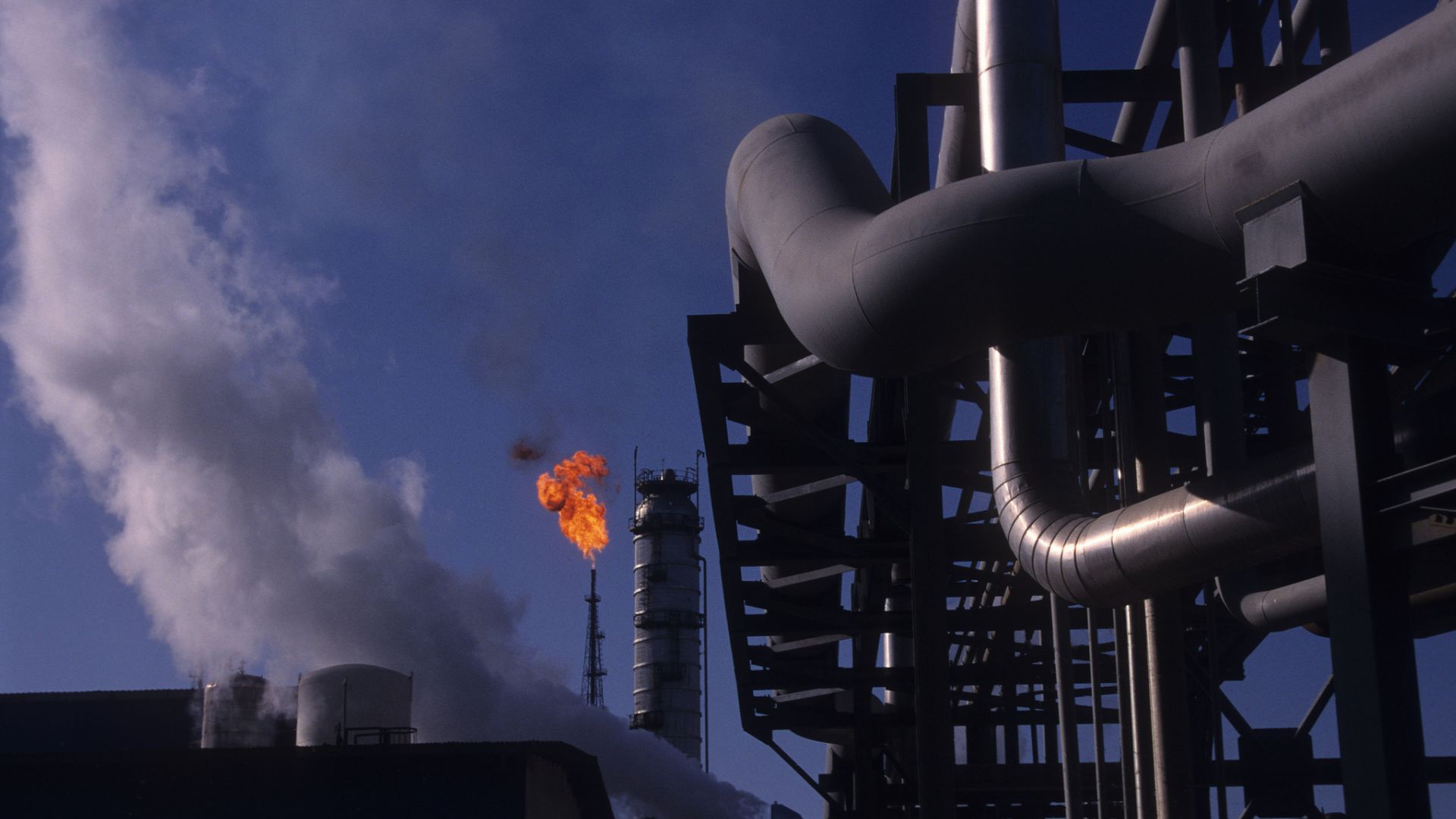 Flames rise above a methanol plant and oil well on Kharg Island in the Persian Gulf, off the coast of Iran, in March 2000. /Kaveh Kazemi/Getty Images
