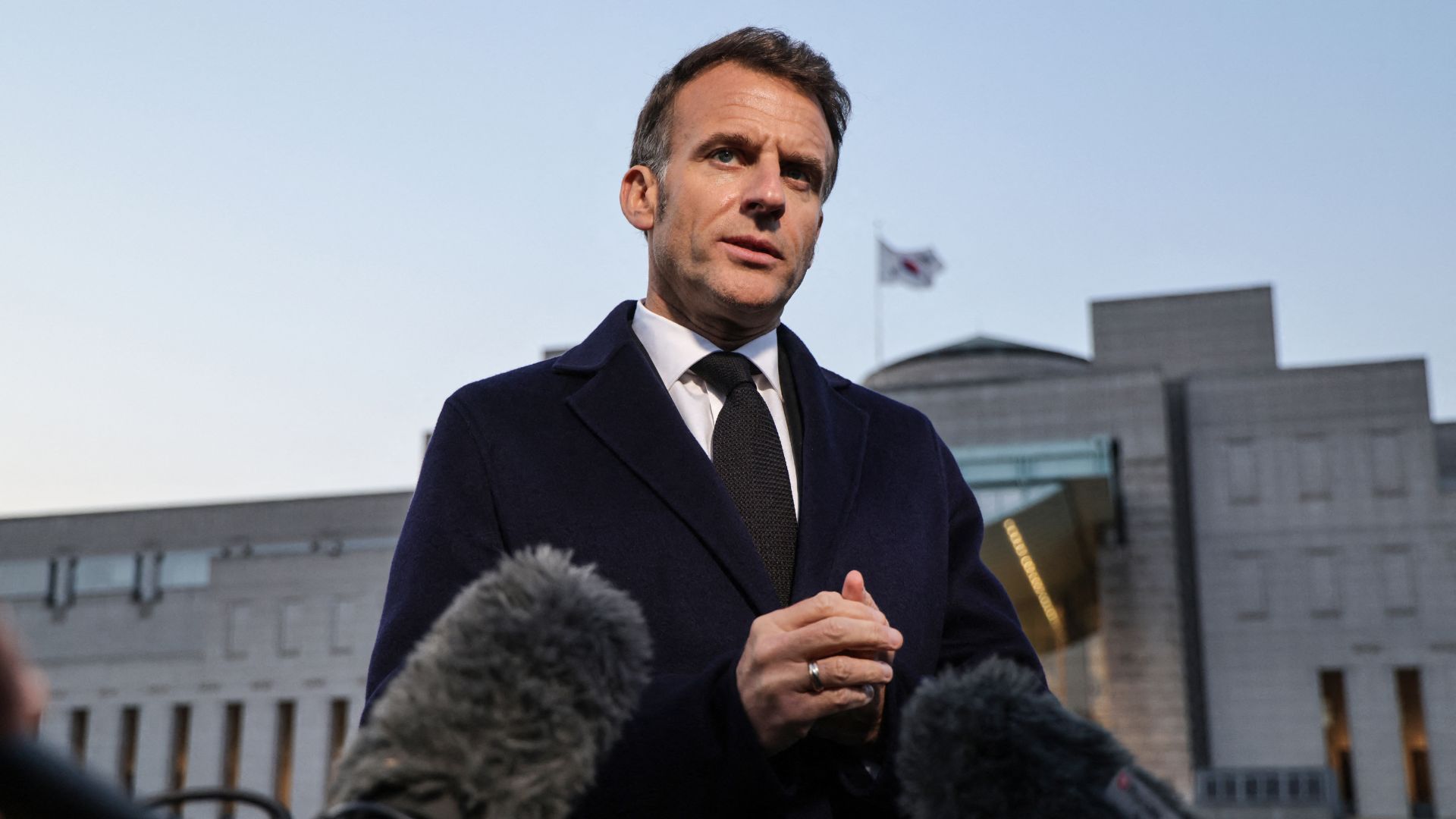 Macron speaks to the press during a visit to Seoul on April 2. /Ludovic Marin/AFP
