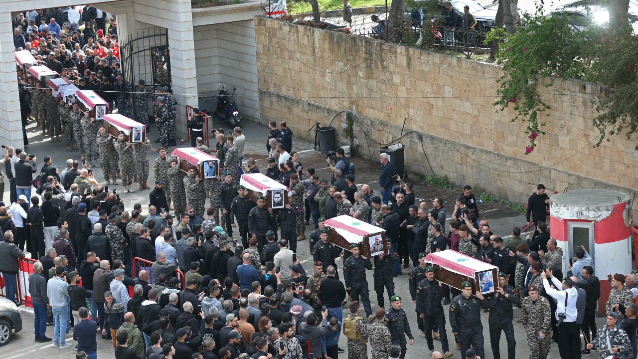 Mourners carry the coffins of the members of Lebanon's State Security agency, who were killed by an Israeli strike, during their funeral procession in Sidon. /Mahmoud Zayyat/AFP