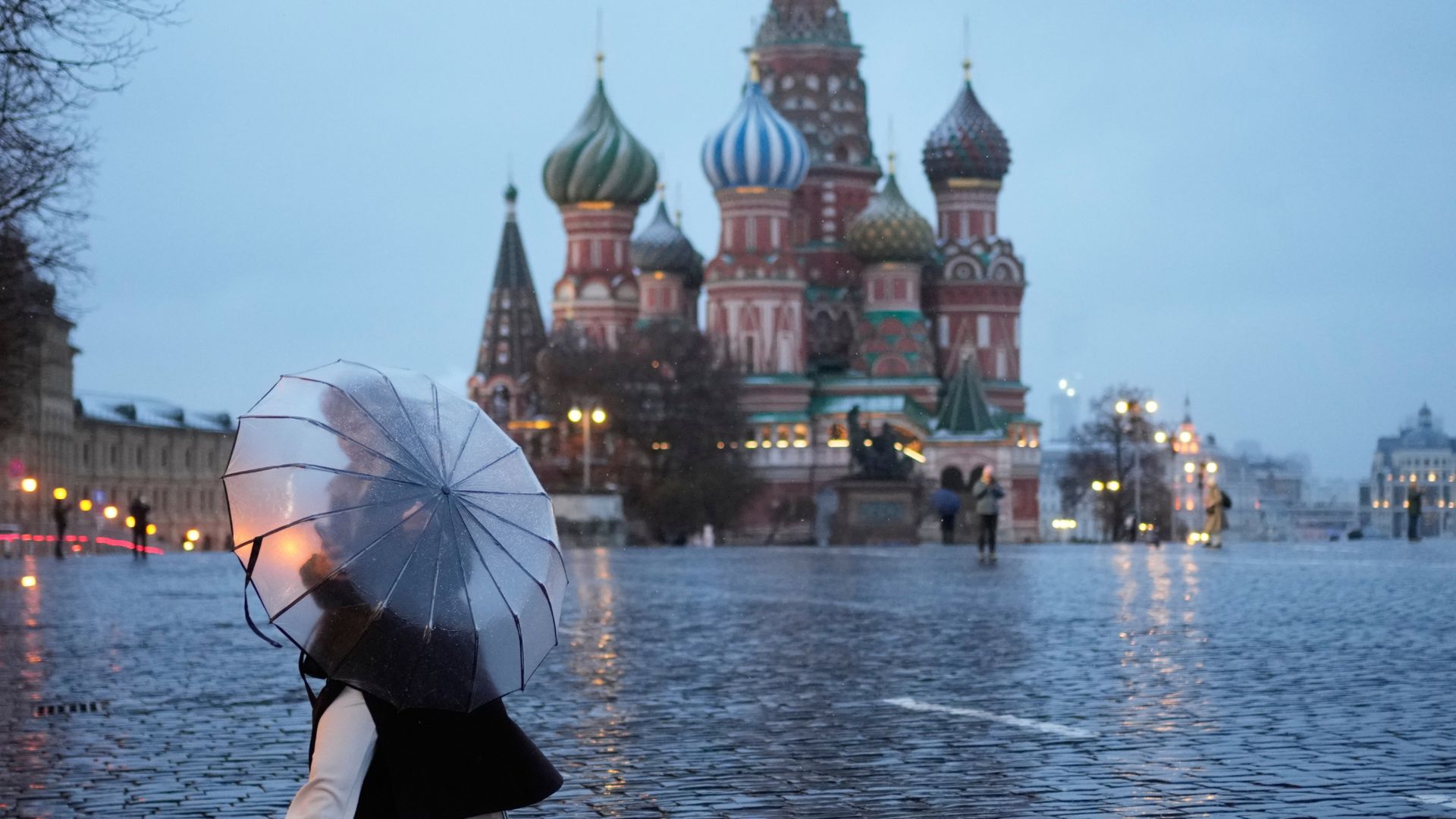 A woman holds an umbrella while she walks through Red Square as it drizzles in Moscow, on April 9. /Pavel Bednyakov/AP 