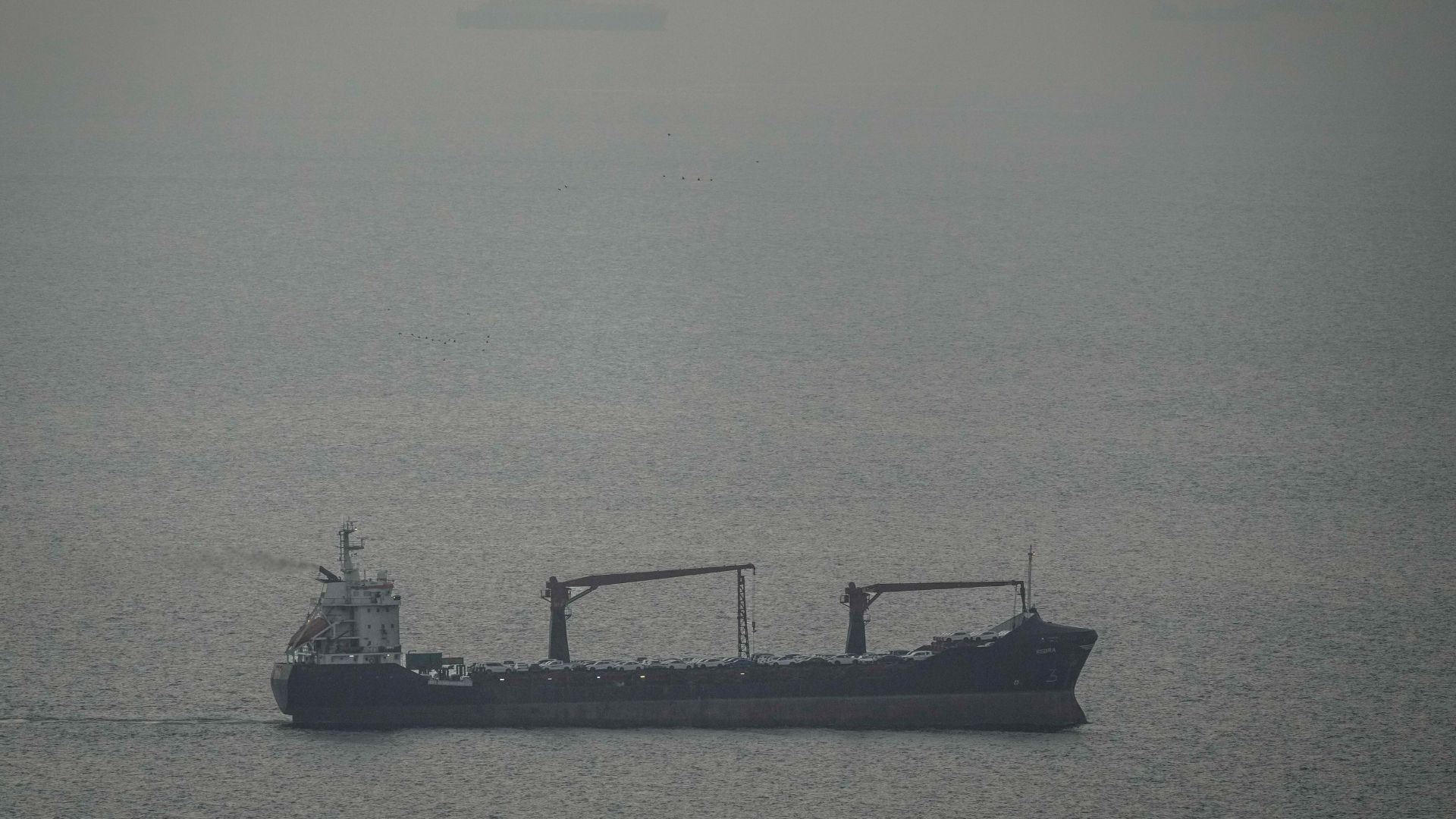 A cargo ship carrying vehicles sails through the Arabian Gulf toward the Strait of Hormuz in the United Arab Emirates/Sunday 22 March 2026/AFP.