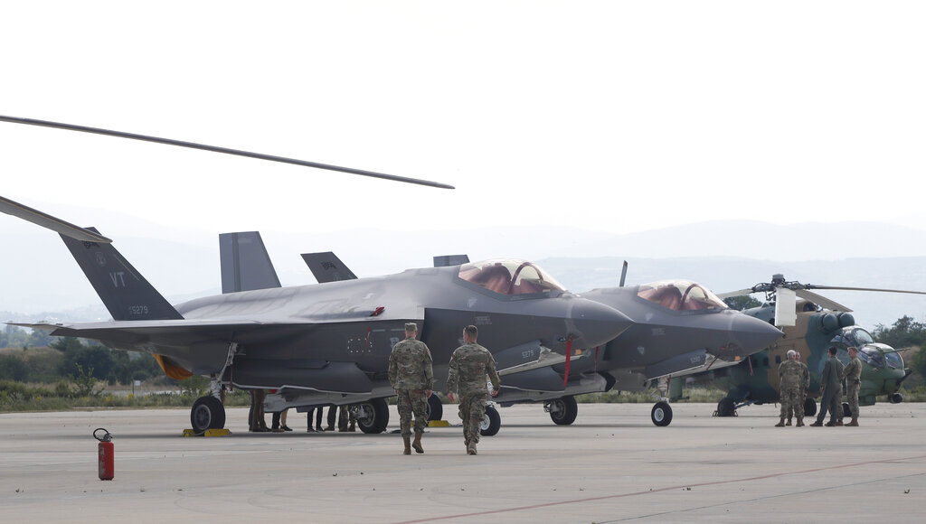 US military officers walk next to F-35 fighter jets of the Vermont Air National Guard at a military base in Skopje, North Macedonia. /Boris Grdanoski/AP Photo