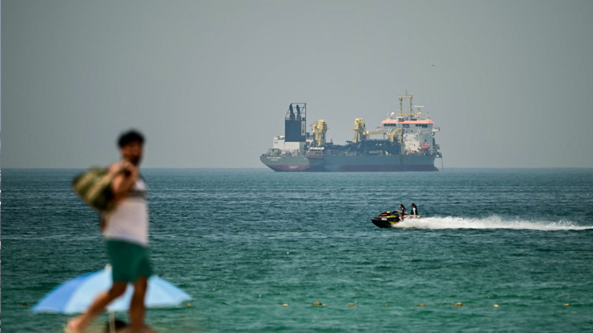 A commercial vessel is seen off the coast of Dubai on April 20. /AFP