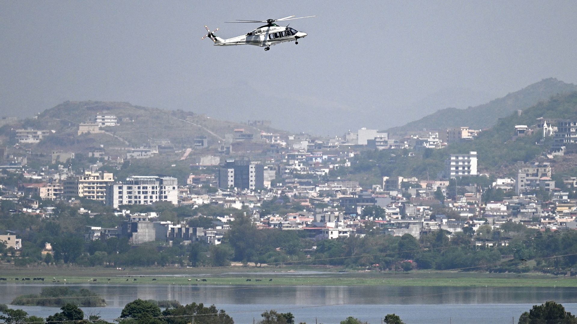A helicopter flies over the Red Zone area in Islamabad on April 20, 2026, amid heightened security measures ahead of anticipated US-Iran peace talks. /Aamir Qureshi/AFP
