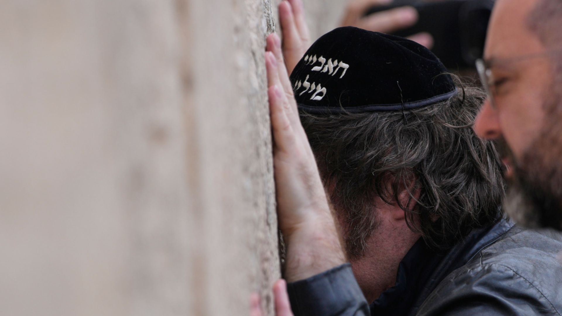 Argentina's President Javier Milei wears a Jewish skullcap embroidered with his name in Hebrew as he visits the Western Wall, the holiest site where Jews can pray, in Jerusalem's Old City, on Sunday./ Ohad Zwigenberg/AP
