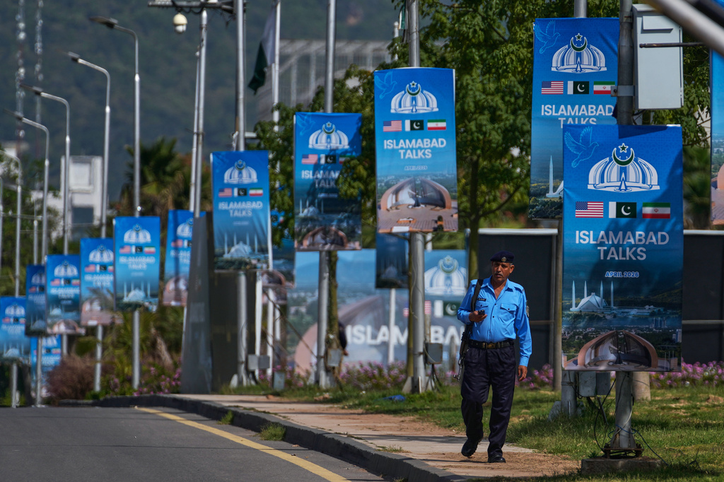 A police officer walks past billboards near the Serena Hotel ahead of the second round of negotiations between the US and Iran, in Islamabad, Pakistan, Tuesday, April 21, 2026. /Anjum Naveed/AP