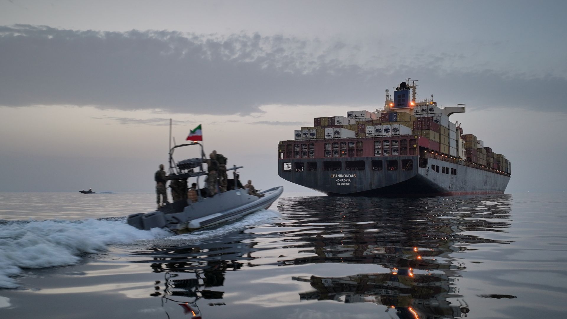IRGC speedboat approaches the cargo ship Epaminondas during what state media described as the seizure of one of two vessels accused of violations in the Strait of Hormuz, April 21, 2026. /Meysam Mirzadeh/Tasnim News Agency via AP