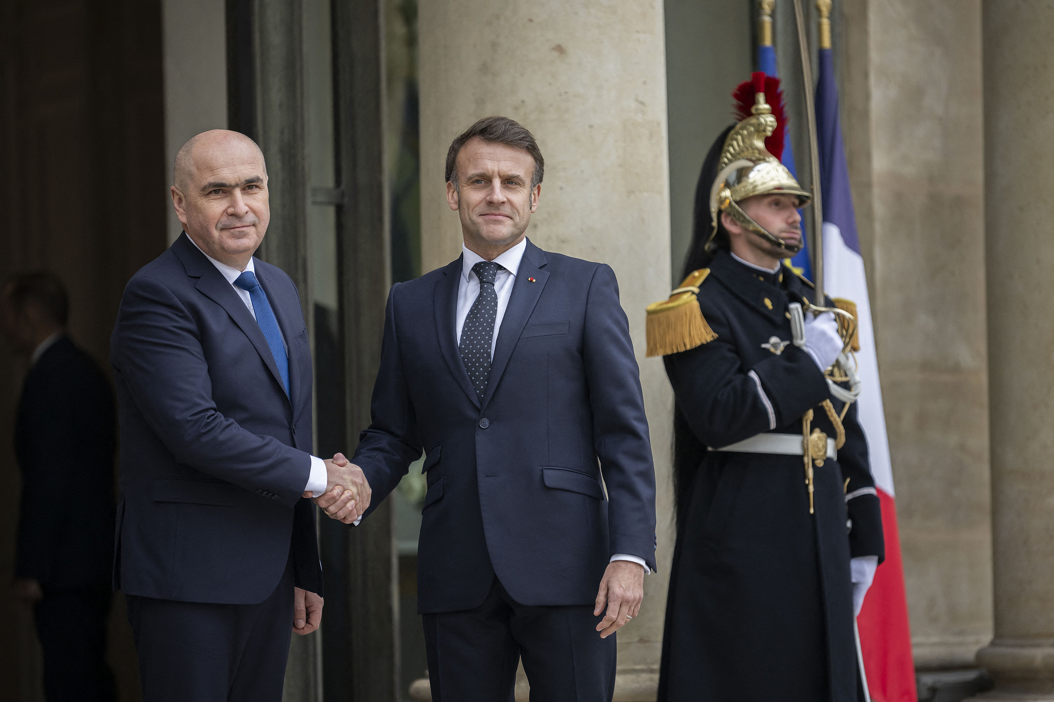 French President Emmanuel Macron welcomes Ilie Bolojan at the Élysée Palace in Paris on February 19, 2025. /CFP