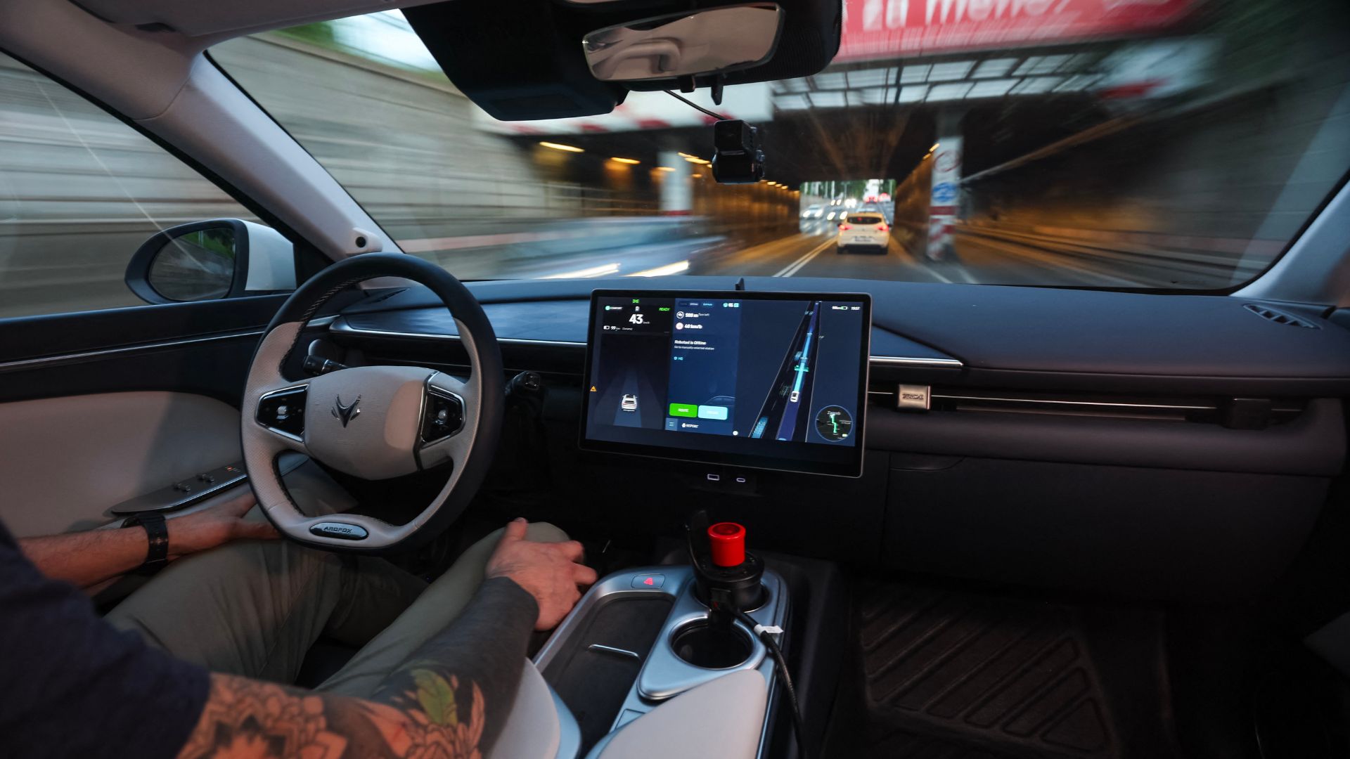 View of the steering wheel and control screen of a Verne RoboTaxi while driving through central Zagreb. /Marko Perkov/AFP